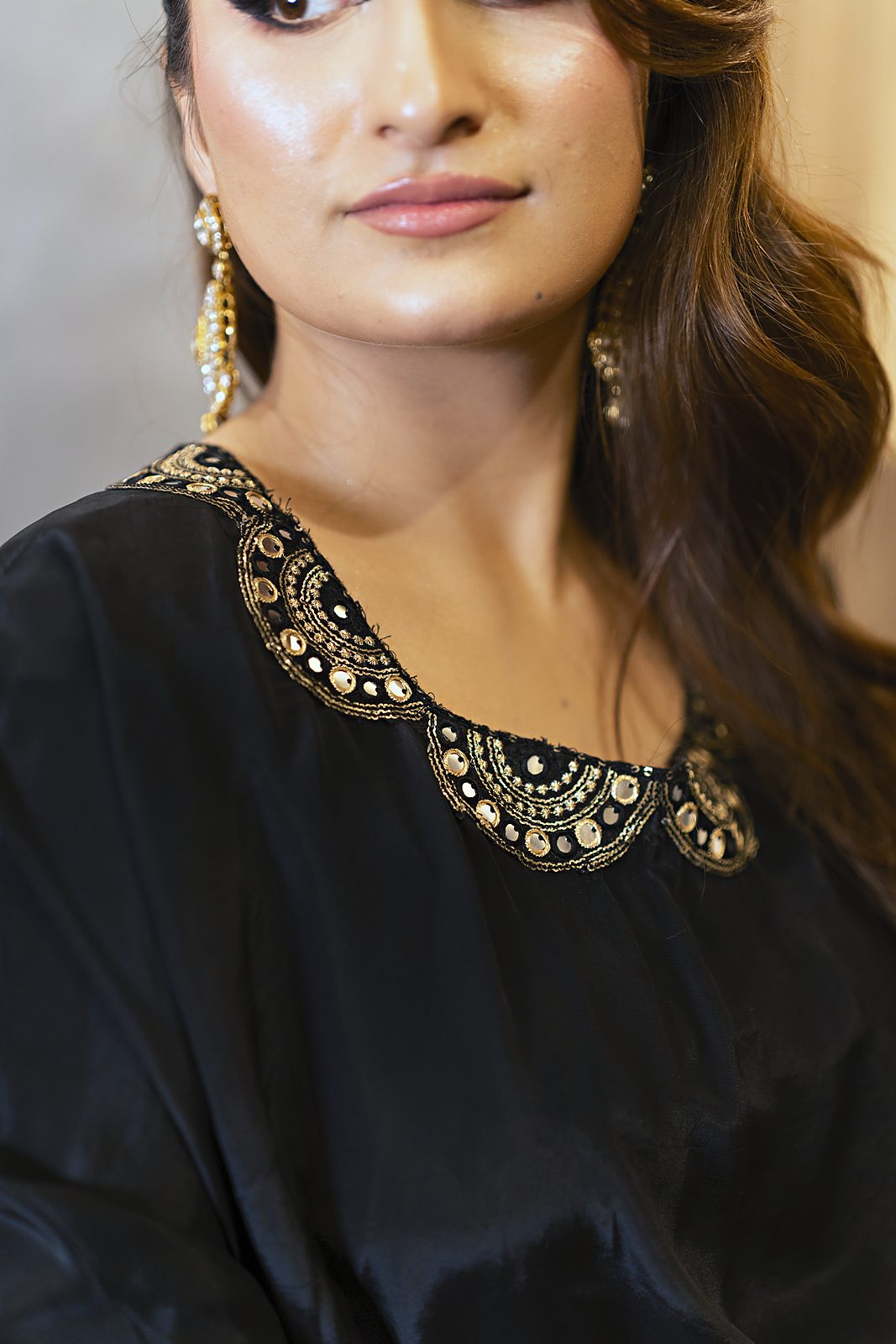 D lace on the scalloped neckline of a black Russian silk cape dress, close-up