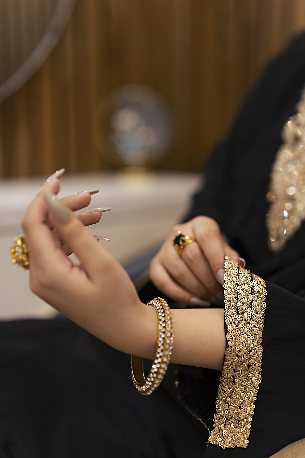 Close-up of the hand-embroidered gold lace cuff