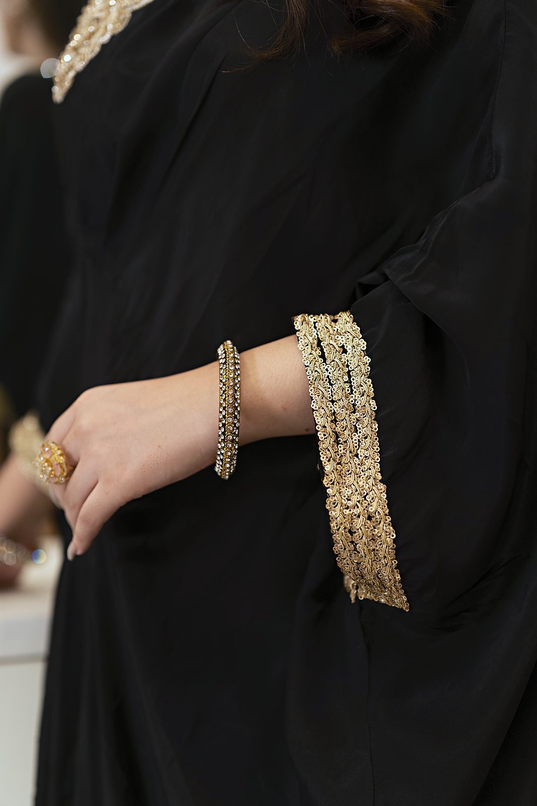 Hand-embroidered thin gold lace on the kaftan cuff