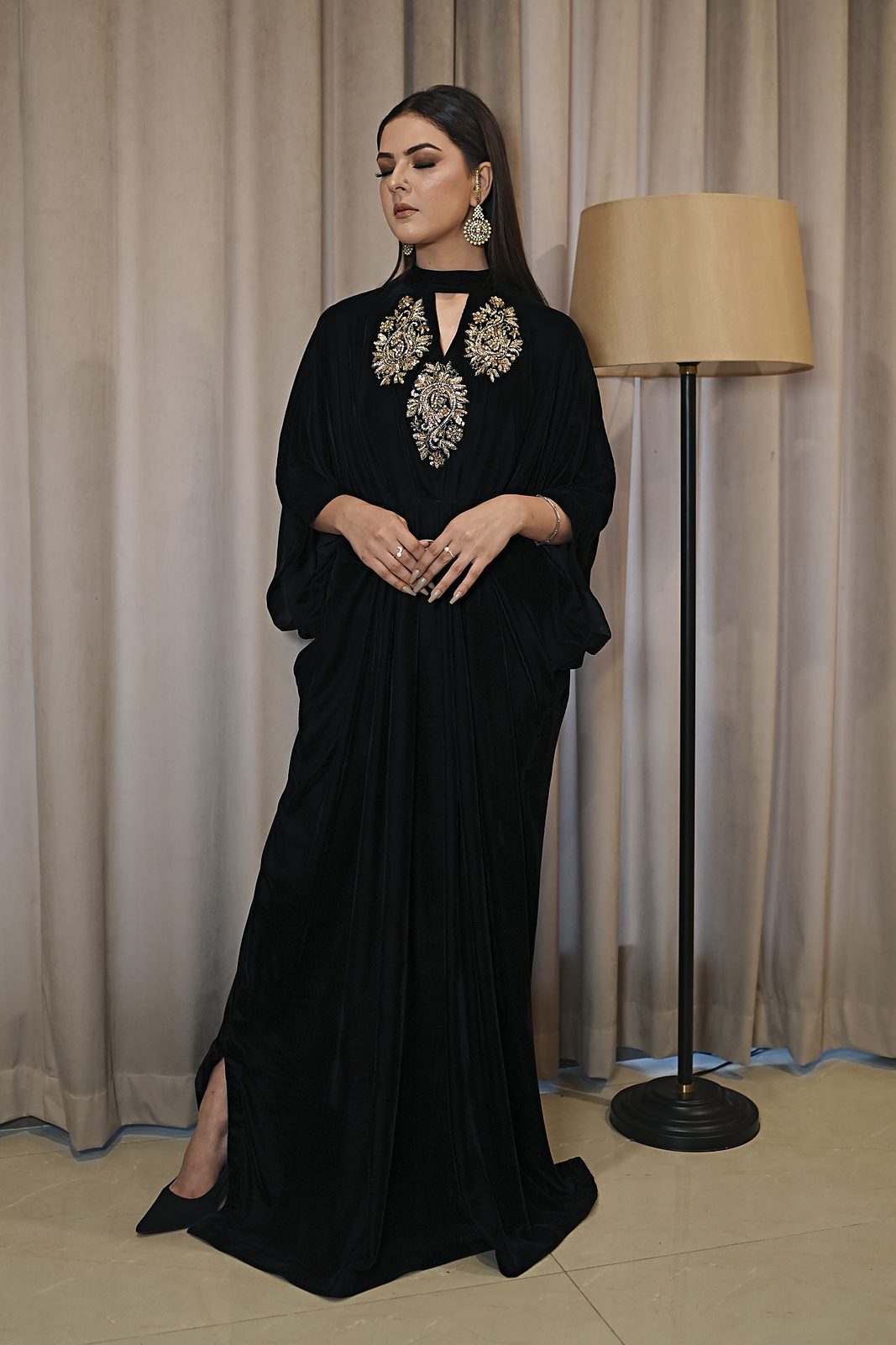 Black micro velvet kaftan with hand-embroidered kora dabka motifs at the keyhole neck, front view